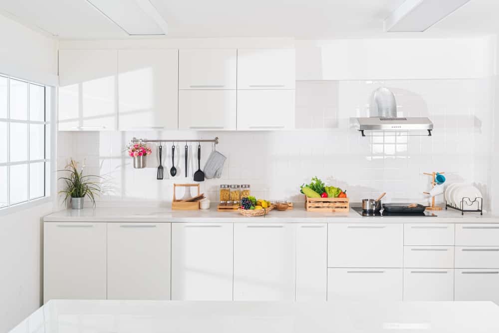 Bright white kitchen designs with natural light and open countertop for daily cooking prep