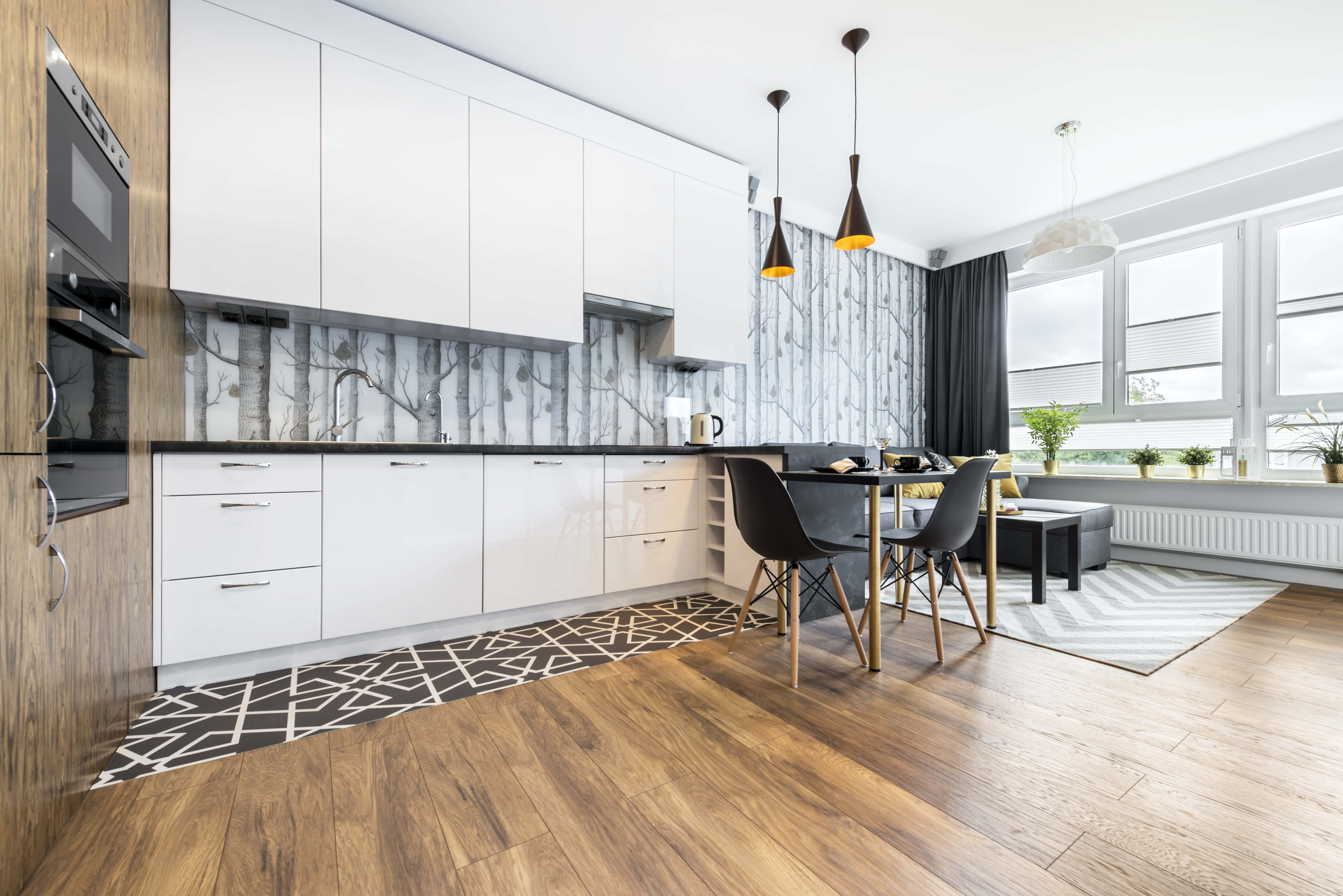 Modern design in contemporary kitchens with sleek cabinets and wood flooring