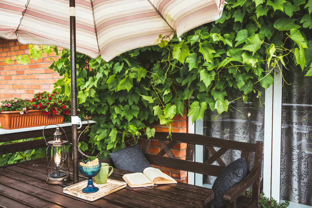 open balcony with a café style table with an umbrella