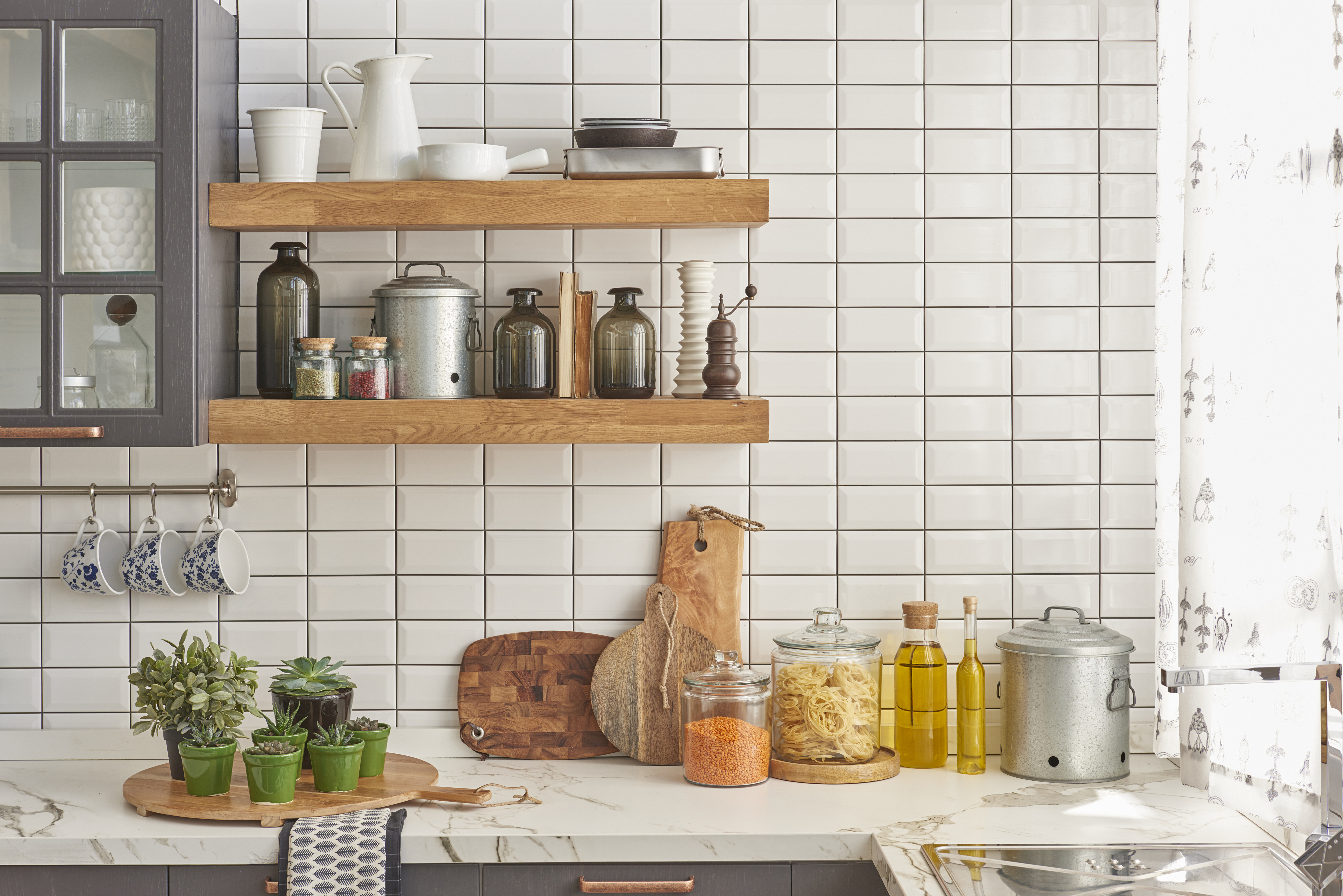 Warm cafe style kitchens with wooden shelves and neatly styled white tile walls