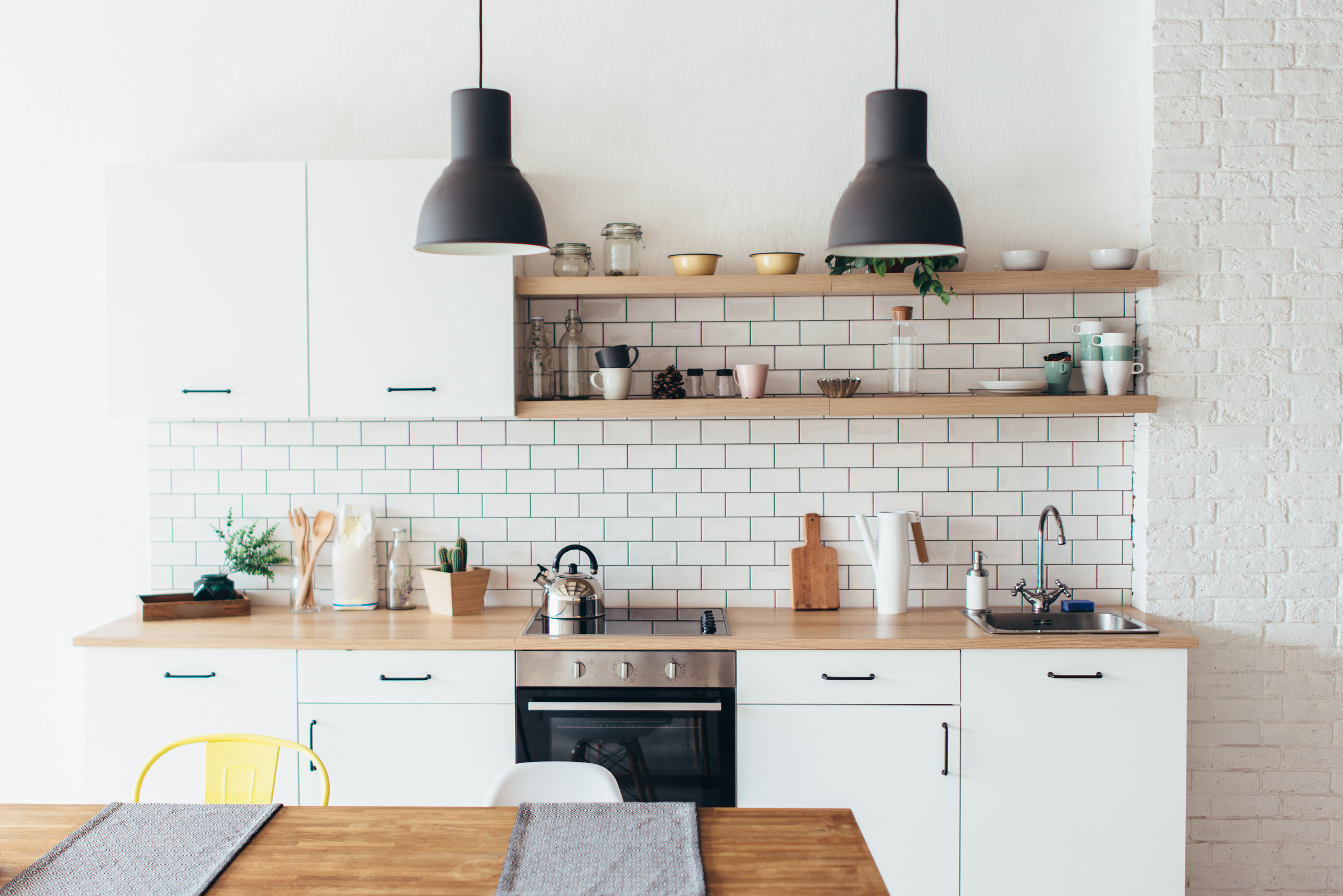 White minimalist design in contemporary kitchens with wood shelves and subway tiles