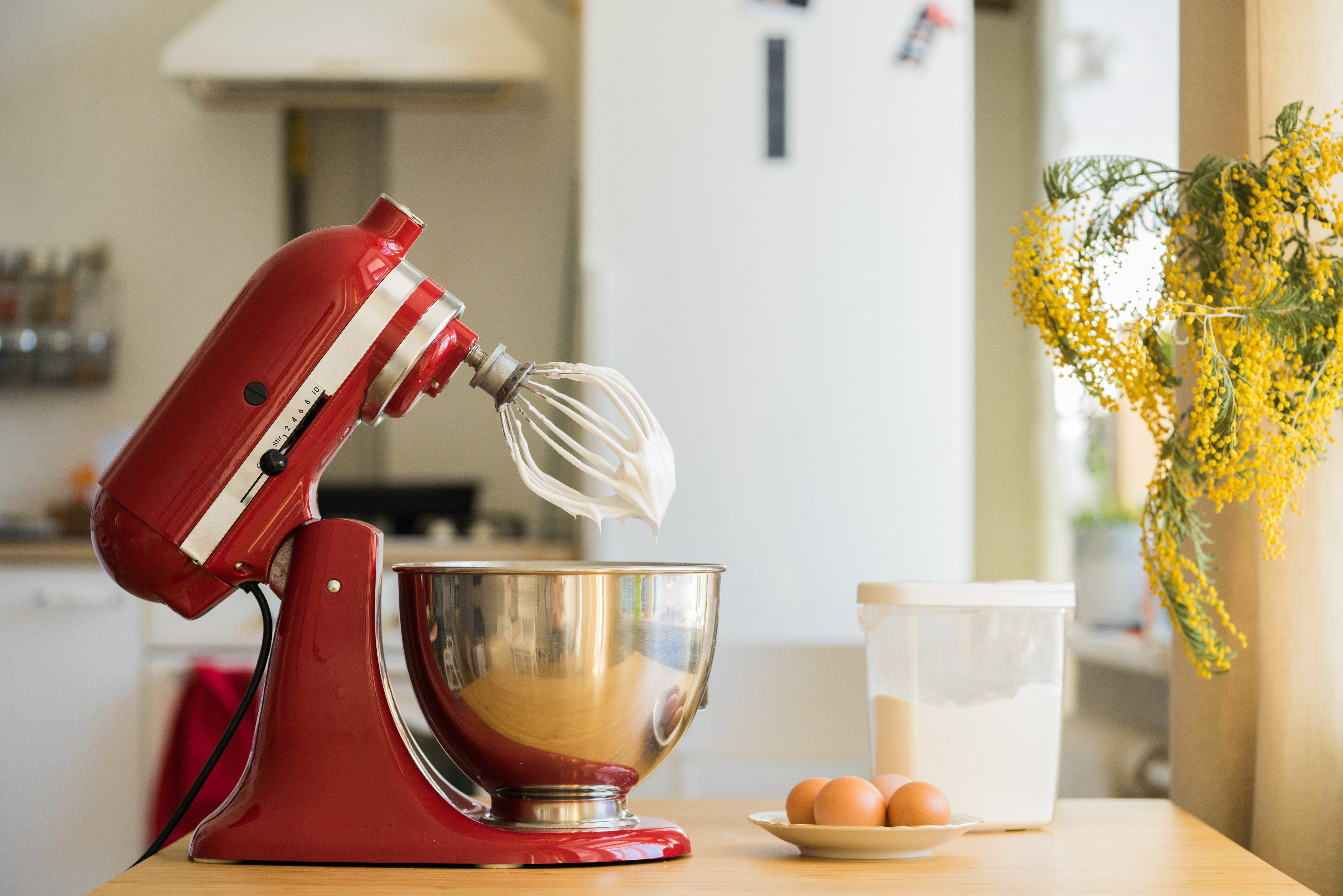 Mixer beside kitchen electrical points with eggs and flour on a countertop