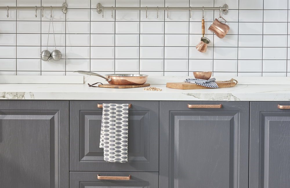 Grey kitchen designs with copper accents and classic cabinetry style