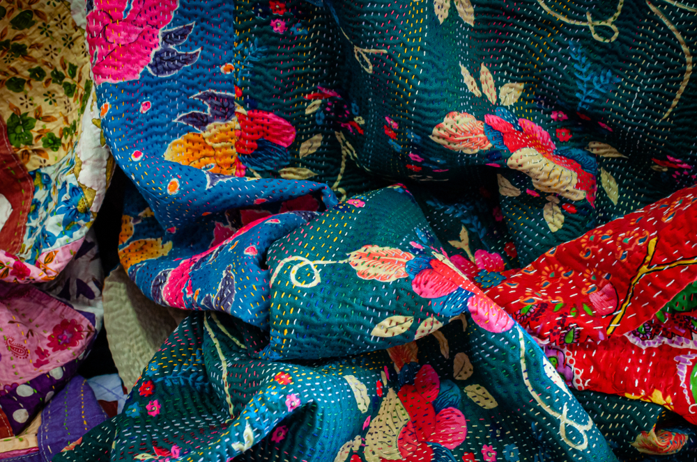 Colorful Bengali home decor textiles with hand-stitched kantha embroidery
