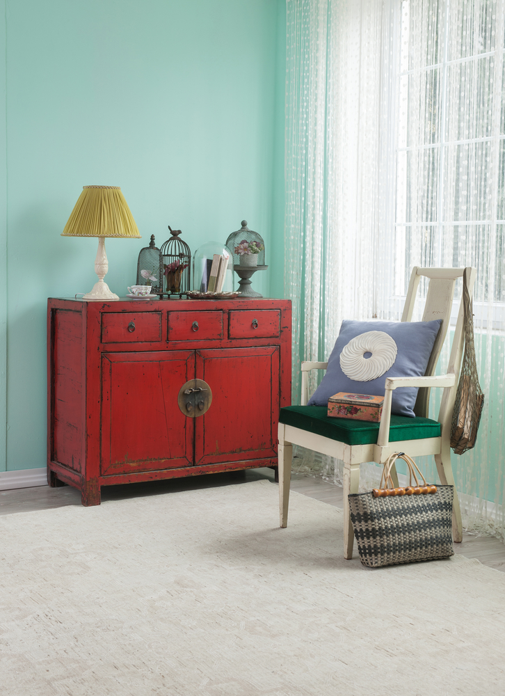 Charming antique Bengali home decor with rustic red cabinet and cultural accents