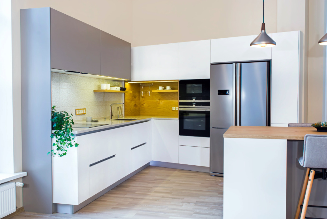 L shaped modular kitchen layout with built-in oven and fridge