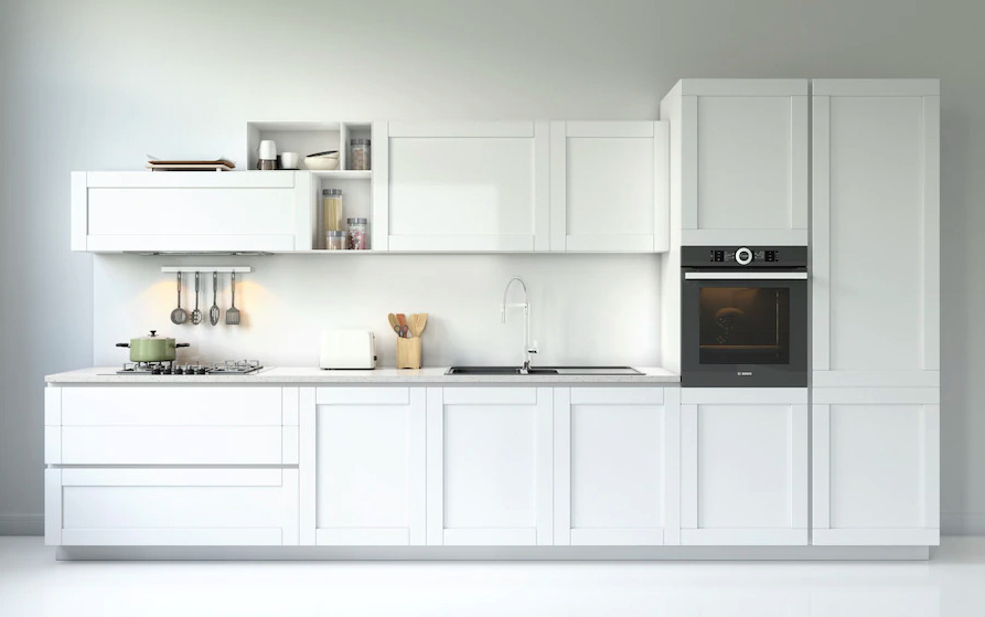Straight kitchen layout with white cabinets and built-in oven