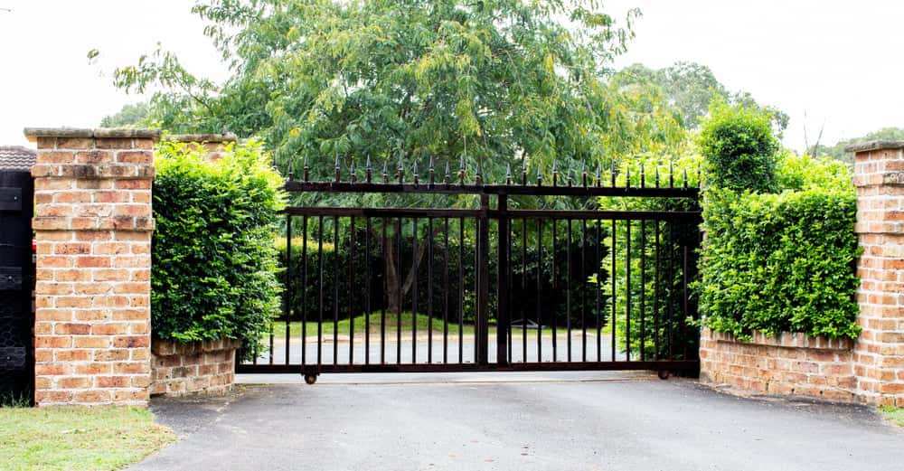 Elegant Brick Boundary Wall Design with wrought iron main gate