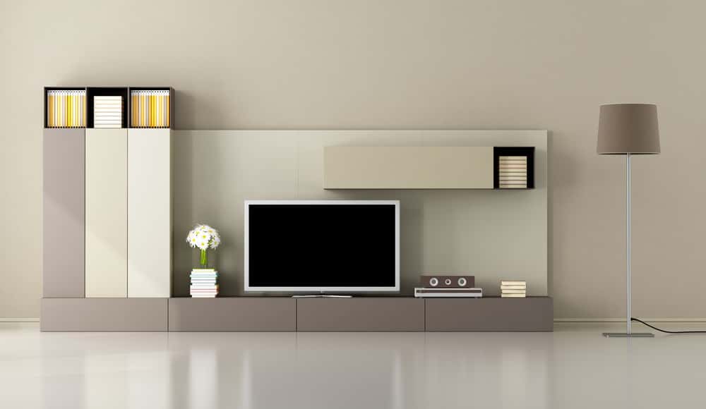 Modern hide TV wires setup with sleek cabinet and clean book decor