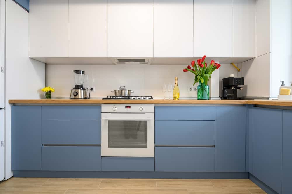 Stylish Parallel Kitchens Designs with modern blue cabinets and wood countertop 
