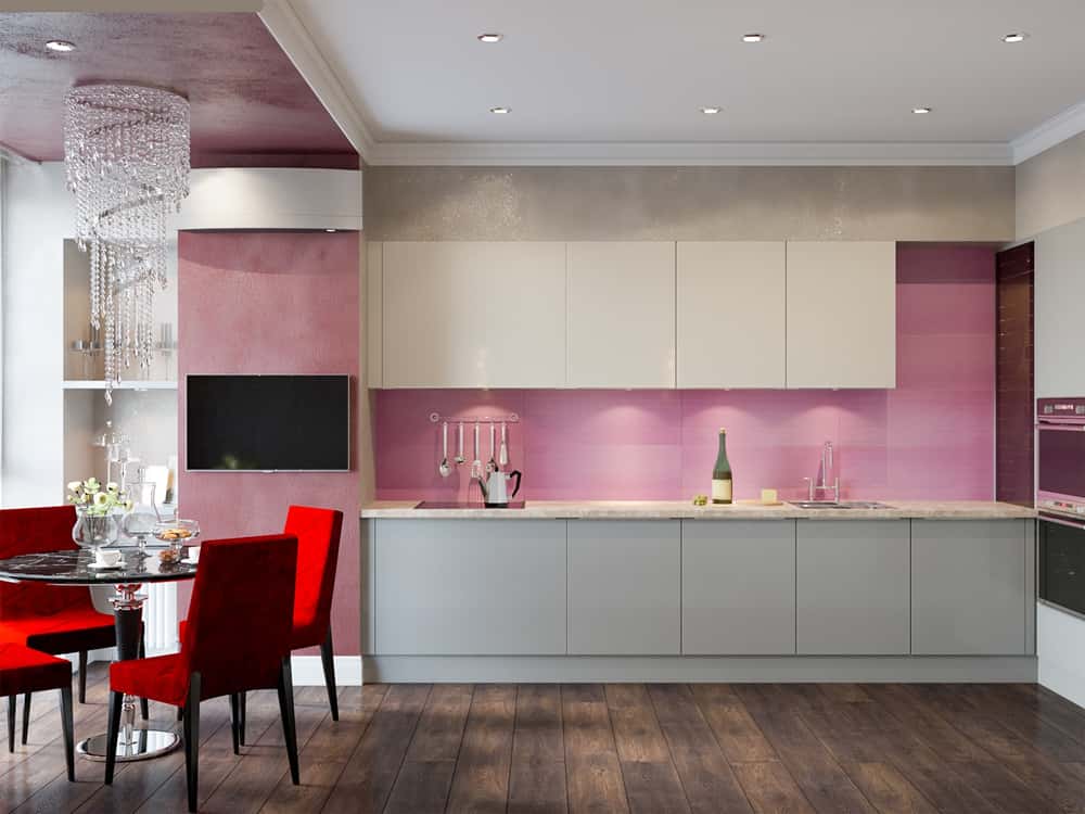 Elegant kitchen laminate designs with glossy pink backsplash and red dining chairs