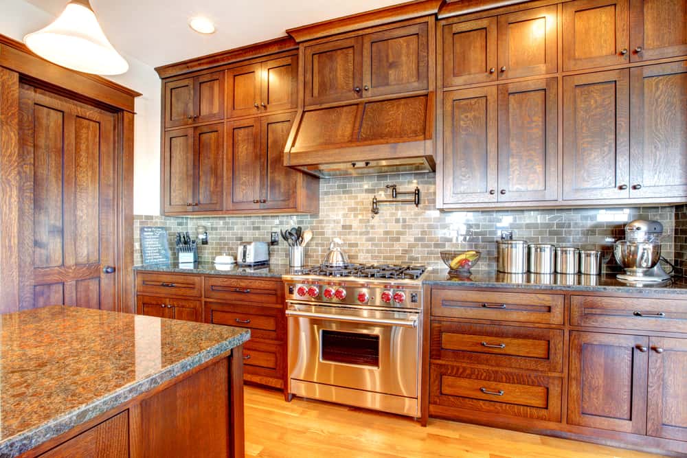 Classic wood cabinetry in contemporary kitchens with stainless steel appliances
