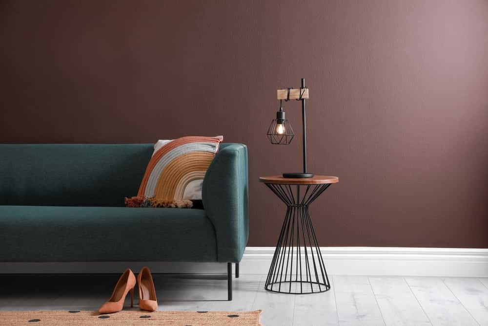 Teal sofa with brown wall