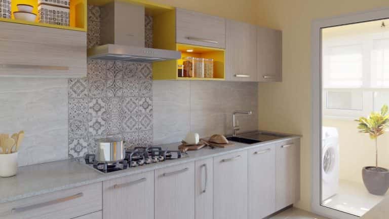 Elegant industrial kitchen with grey cabinets yellow accents and patterned backsplash