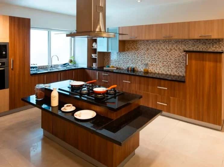 Wooden industrial kitchen with center island hob mosaic backsplash and chimney hood