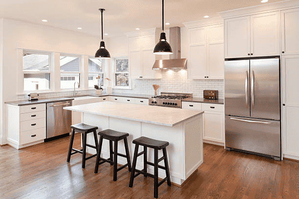 Contemporary kitchen design with white cabinets and wood flooring