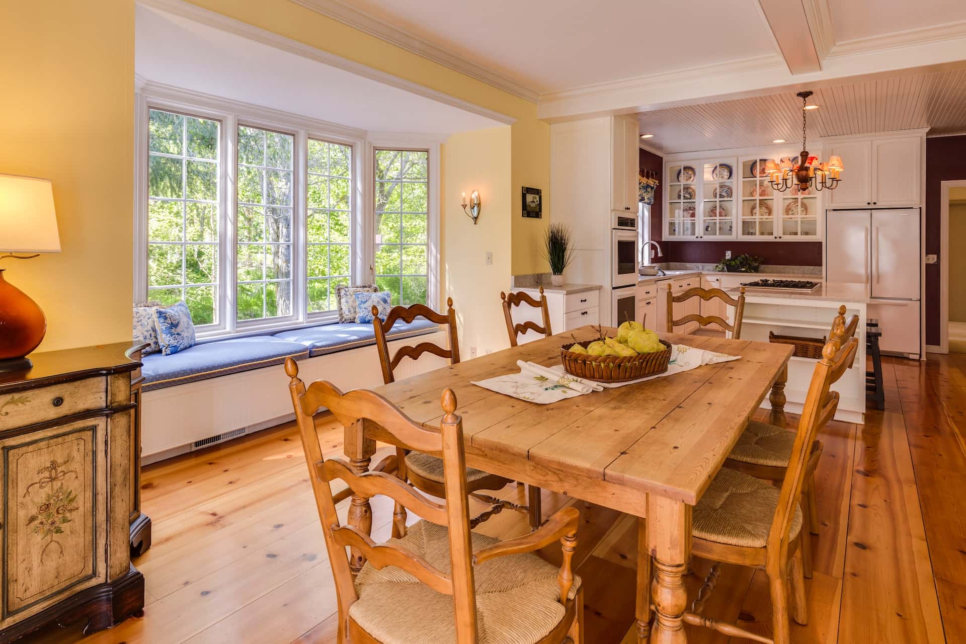 Wooden kitchen table design with six chairs in cozy setup