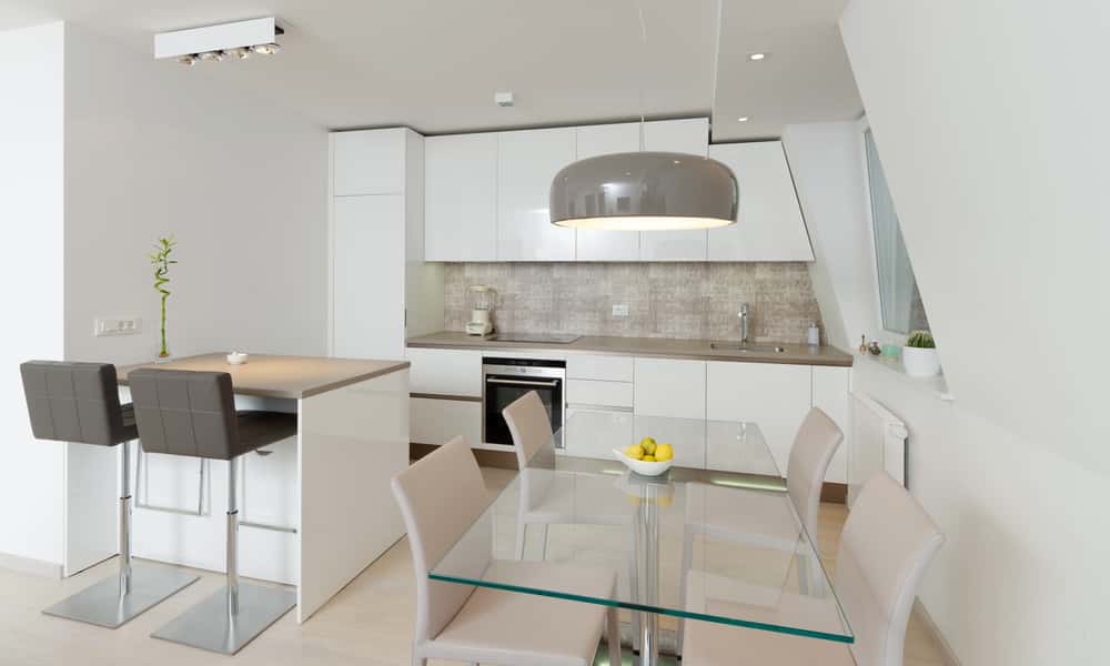 Latest modular kitchen design with island and glass dining area