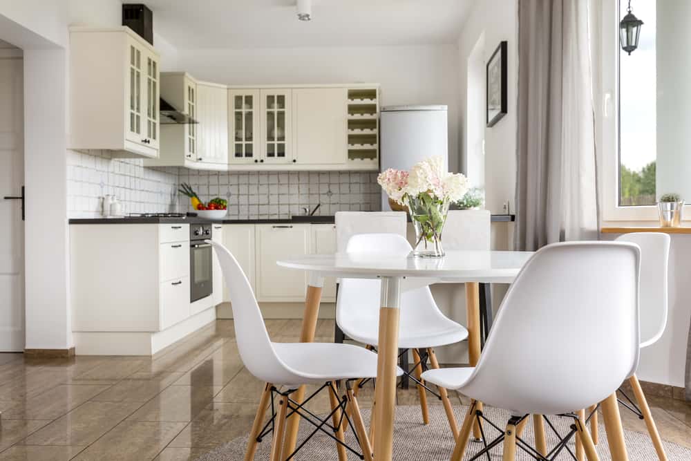 Bright mid century modern kitchen chairs with white seats and wooden legs