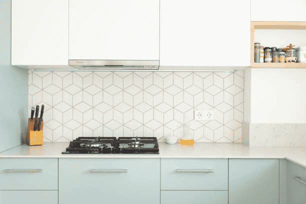 Simple contemporary kitchen design featuring pastel drawers and tile wall