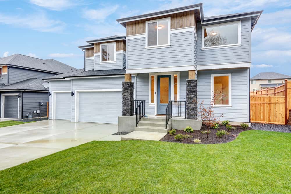 Contemporary front elevation colour combinations with light grey, black stone, and wood accents