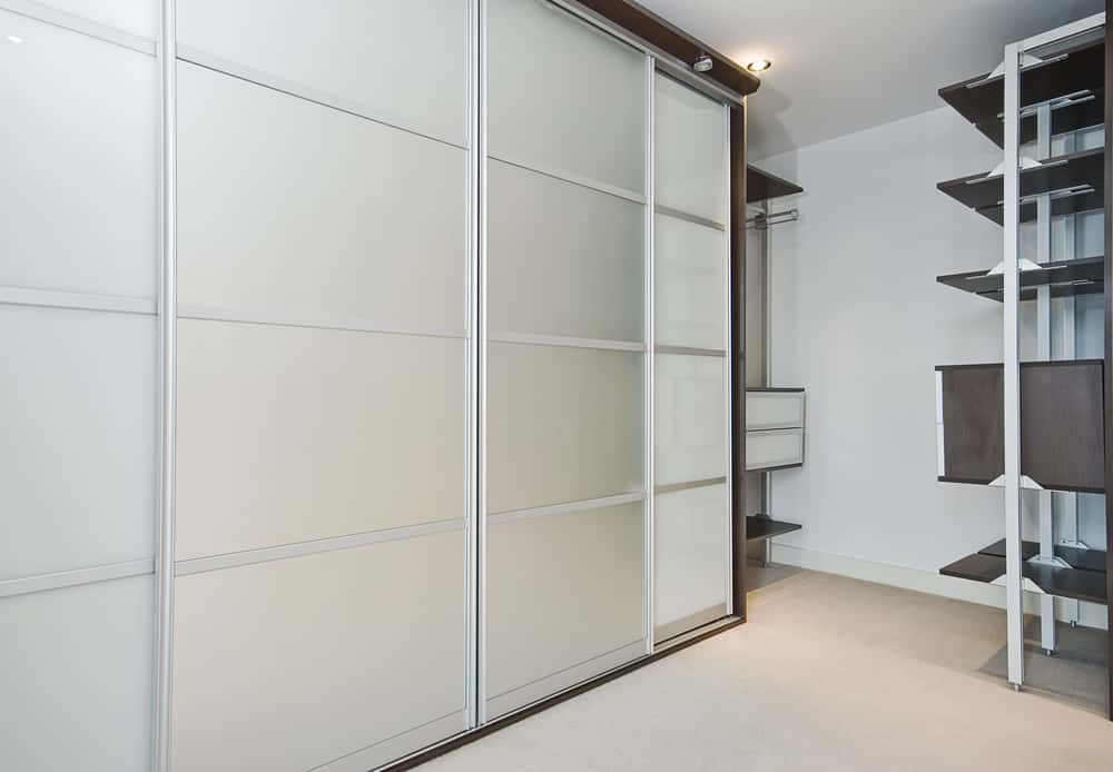 Modern sliding wardrobe handles on frosted glass door panels