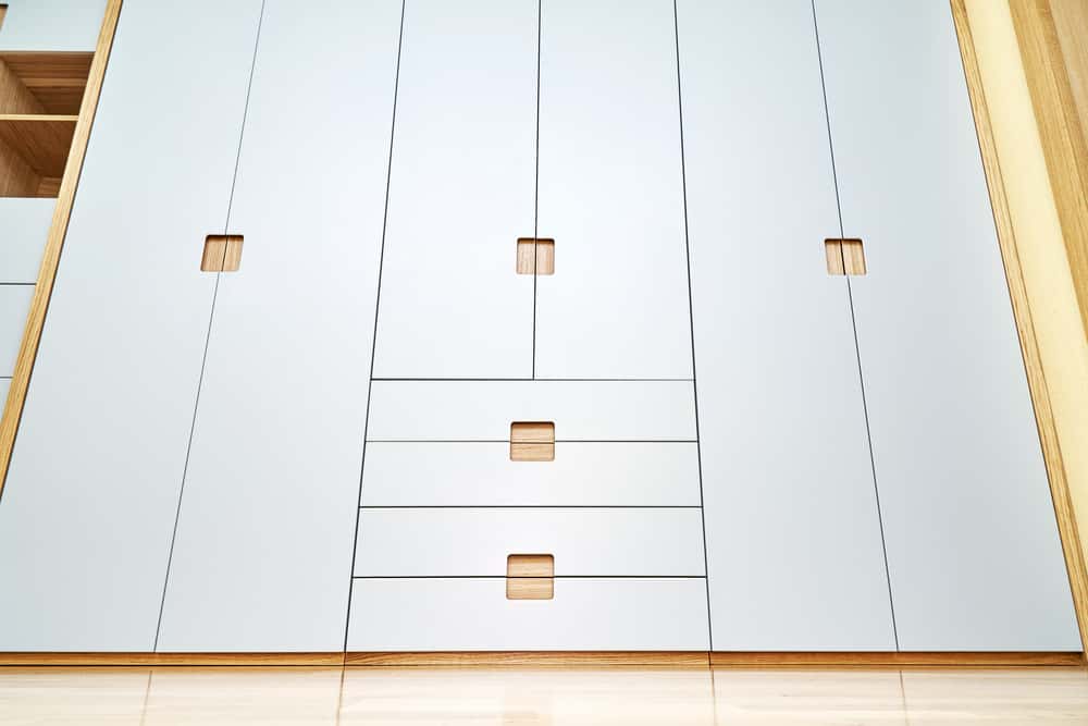 Minimal wardrobe handle style with built-in wooden square pulls