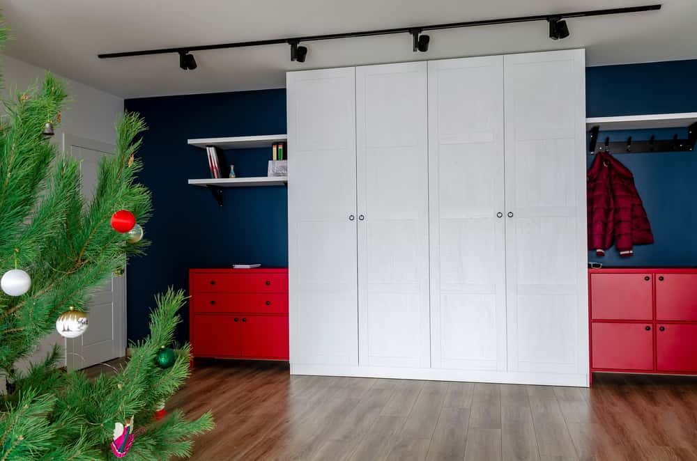 Minimal wardrobe handle on sleek white panel wardrobe