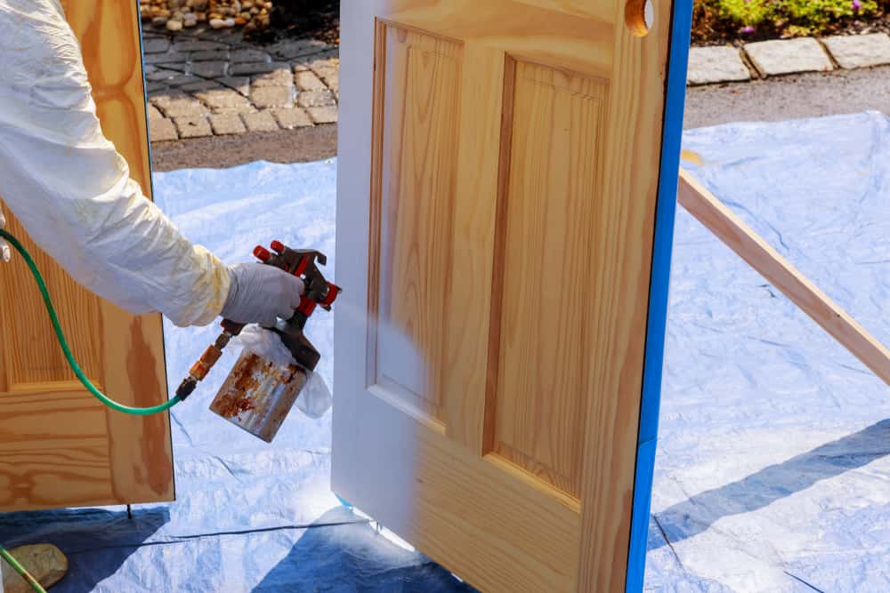 Spray gun used in duco vs pu paint process for wooden door surface finish