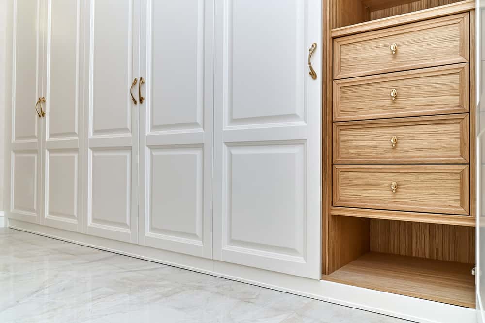 Classic wardrobe handle in gold on white paneled wardrobe design