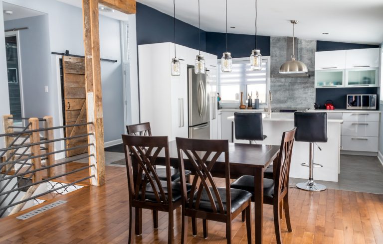 Open modular kitchen design with loft featuring modern white cabinets and dining area