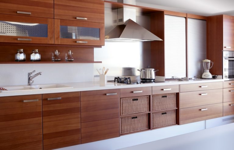 Modular kitchen with loft featuring warm wooden cabinets and sleek modern countertop