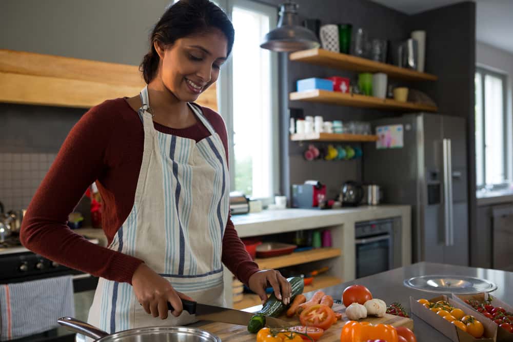 Woman preparing fresh vegetables in a modern kitchen