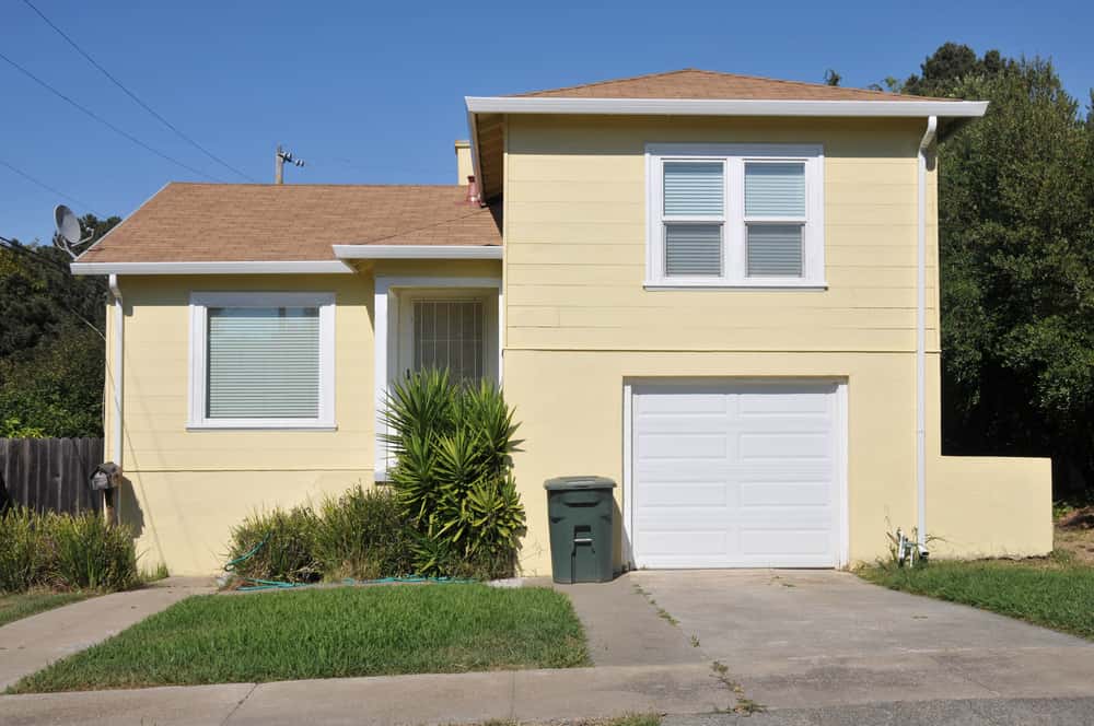 Contemporary single floor house design with yellow exterior walls