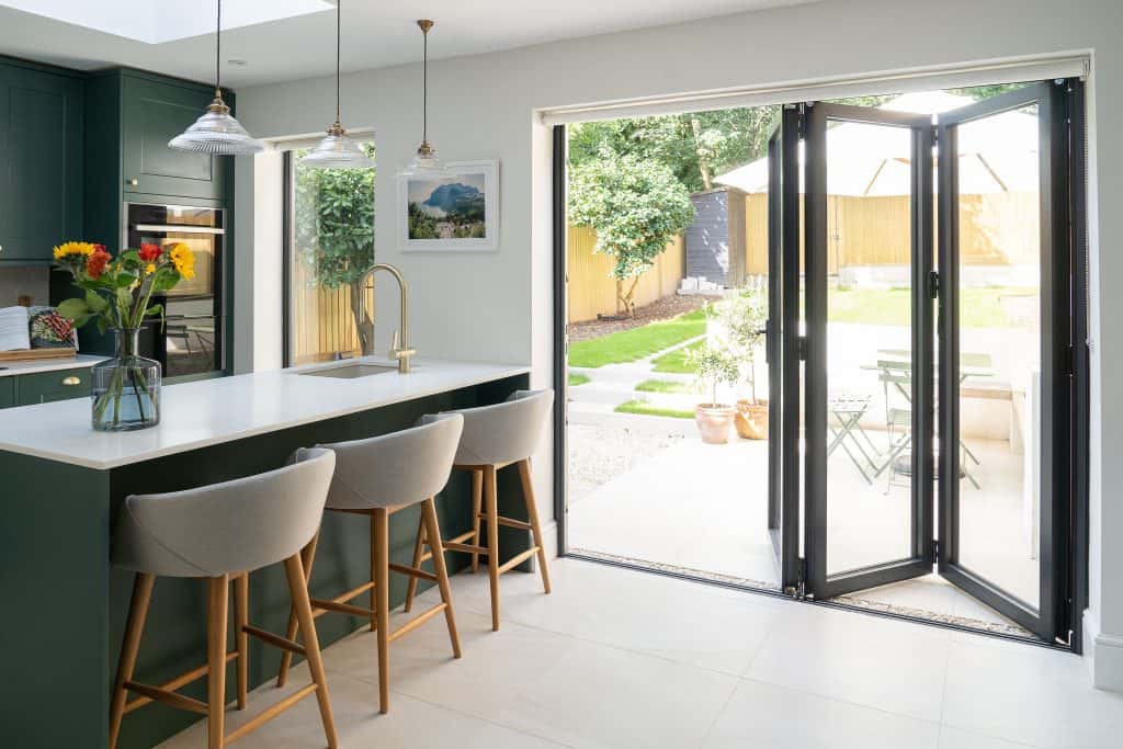 Bright kitchen cupboard door designs with green cabinets and garden-view glass doors