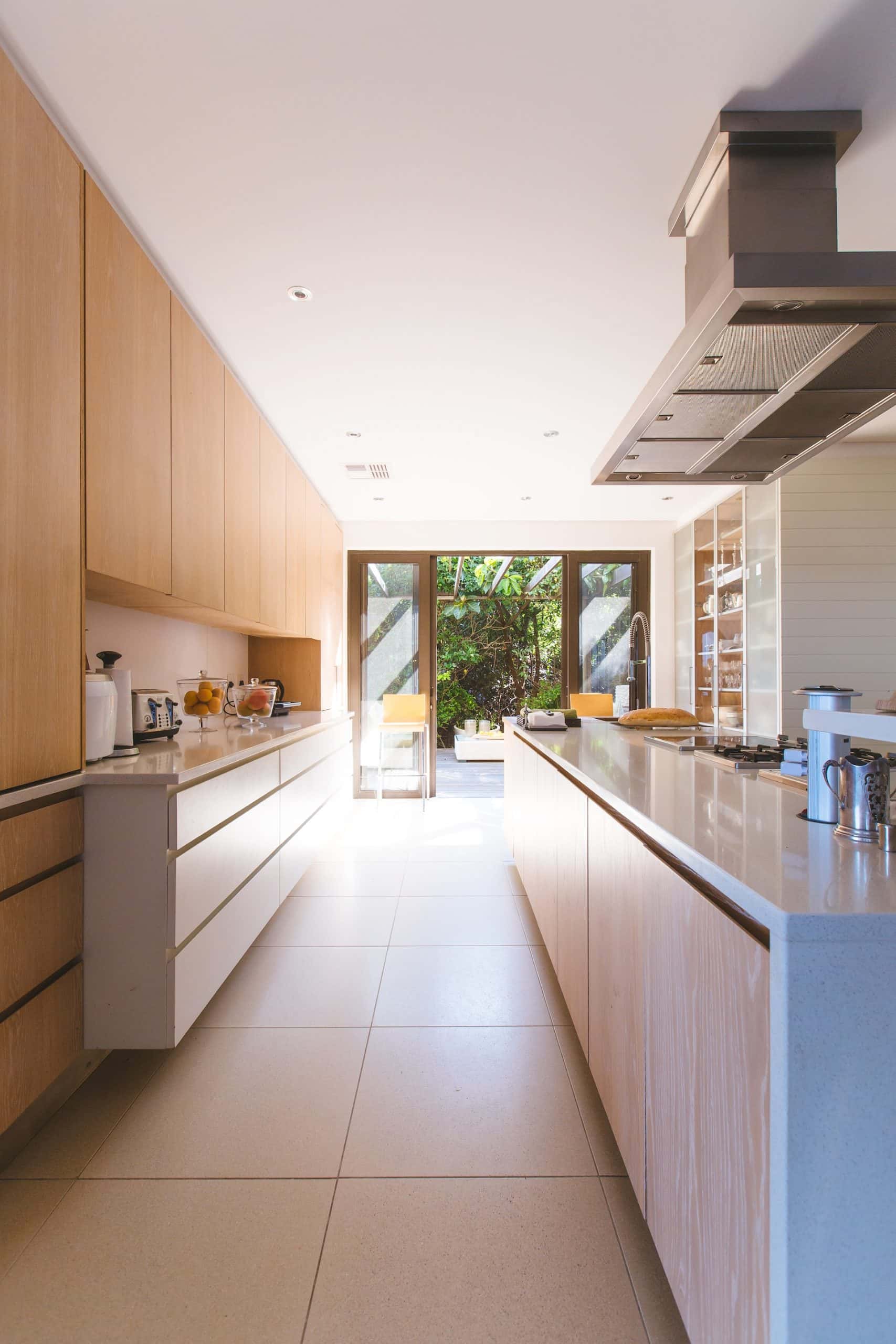 Bright kitchen door designs with full-glass doors opening to a lush garden view