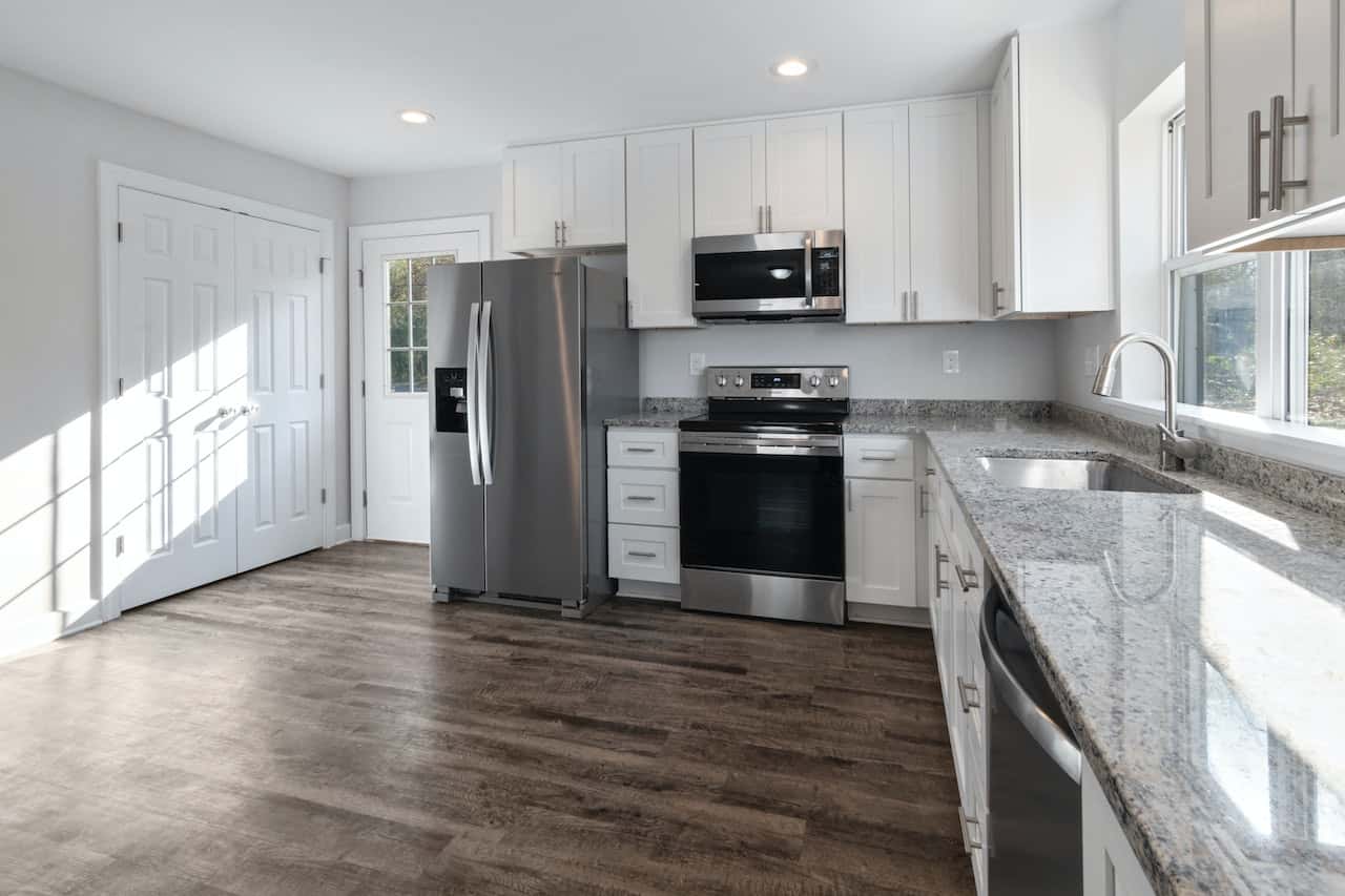 Bright kitchen cupboard door designs with white cabinets and granite countertops