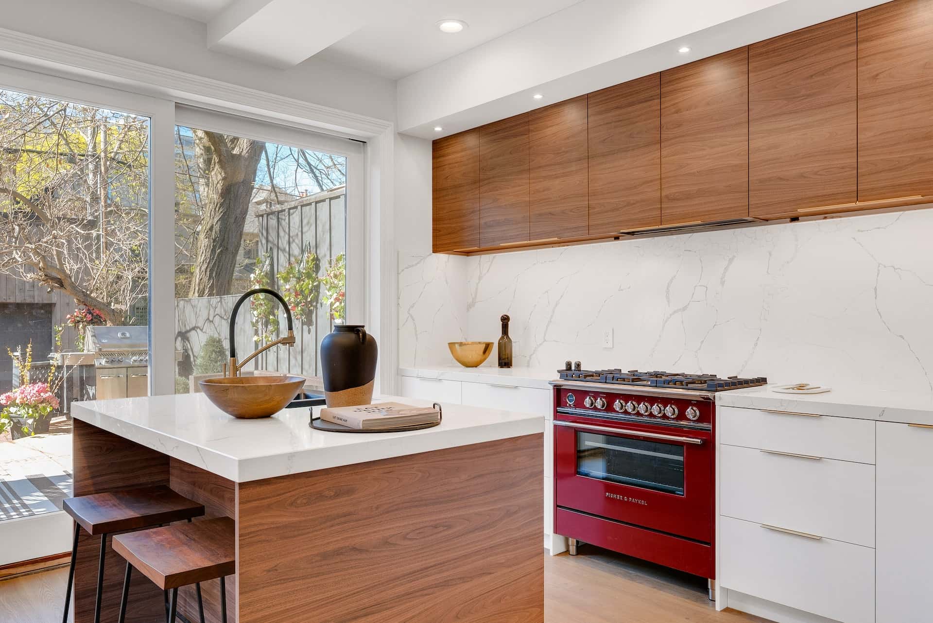 Modern kitchen door designs with large glass panels for natural lighting and garden view