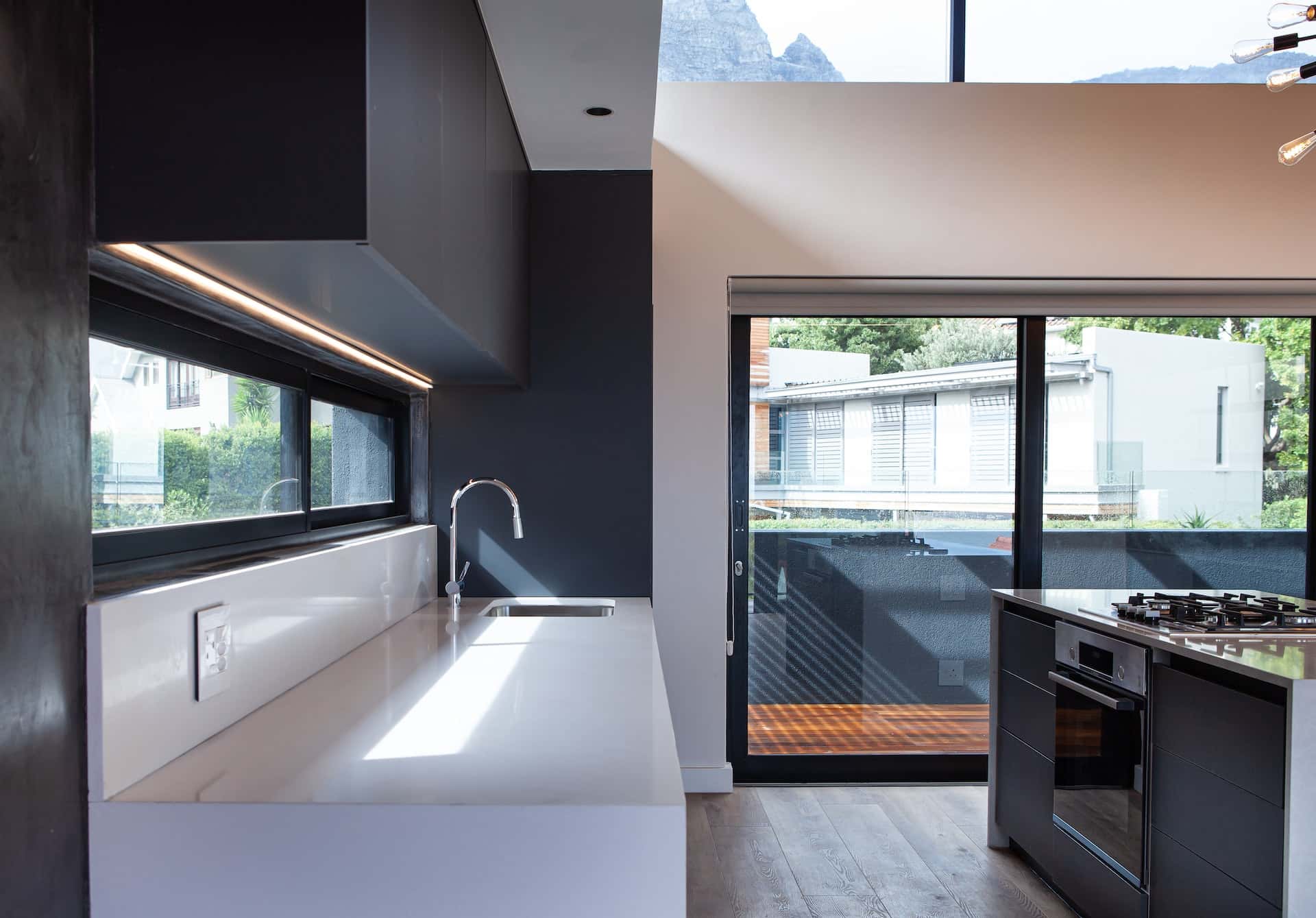 Minimalist kitchen cupboard door designs in monochrome with glass sliders