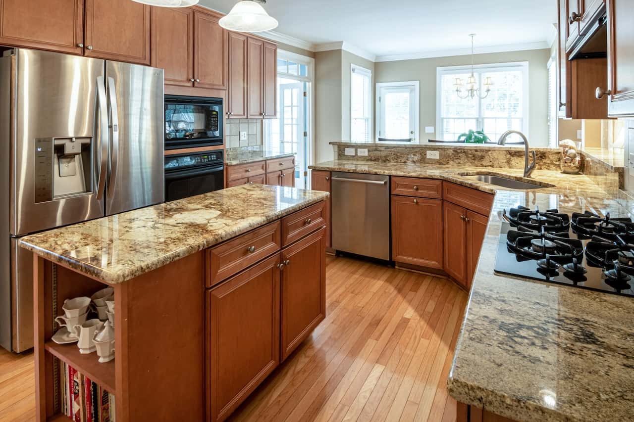 Elegant kitchen cupboard door designs with granite countertops and island setup