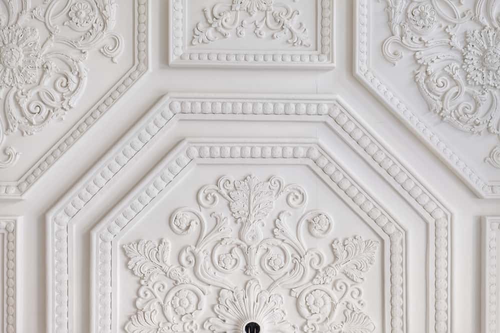 Ornate ceiling with staircase lighting ideas and floral molding accents