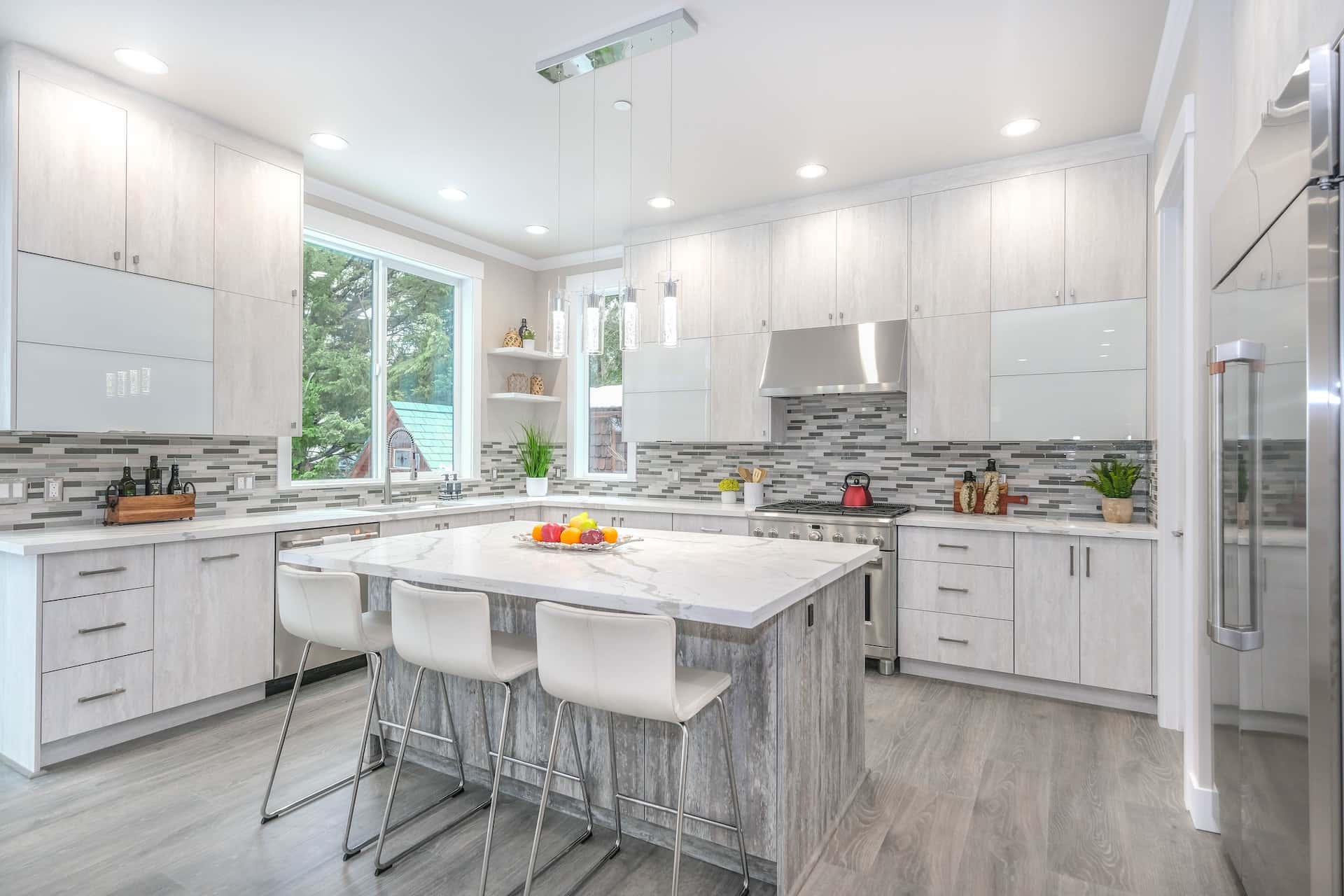 Spacious standard kitchen size with island and light-tone cabinets