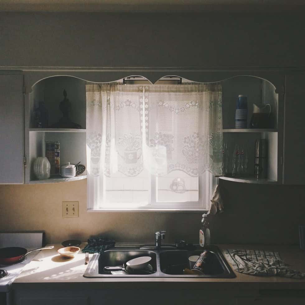 Vintage standard kitchen size with lace curtains and dual sink counter
