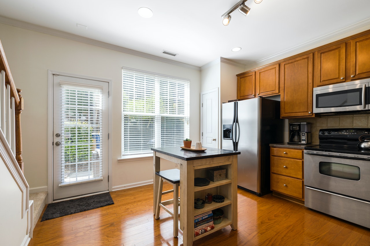 Modern Kitchen Entrance Design with Wooden Cabinets and Natural Light Entry