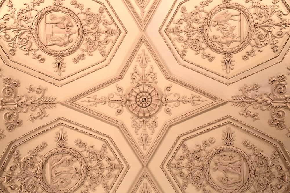 Grand cement ceiling design with artistic medallions and floral plaster carvings