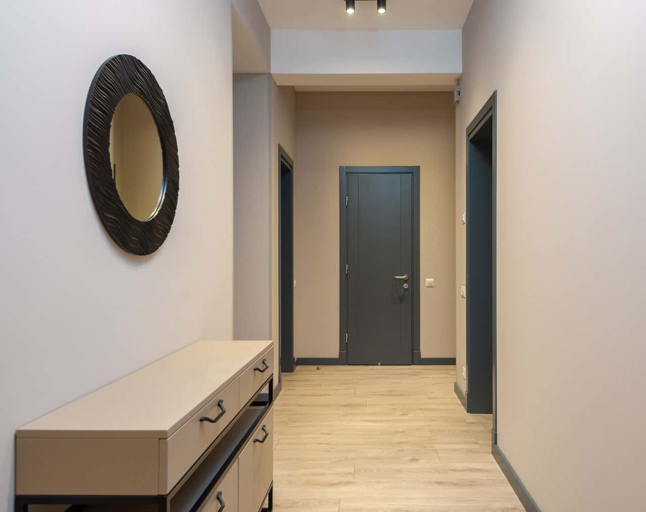 Sleek flush door designs in a modern hallway with wooden flooring and soft lighting