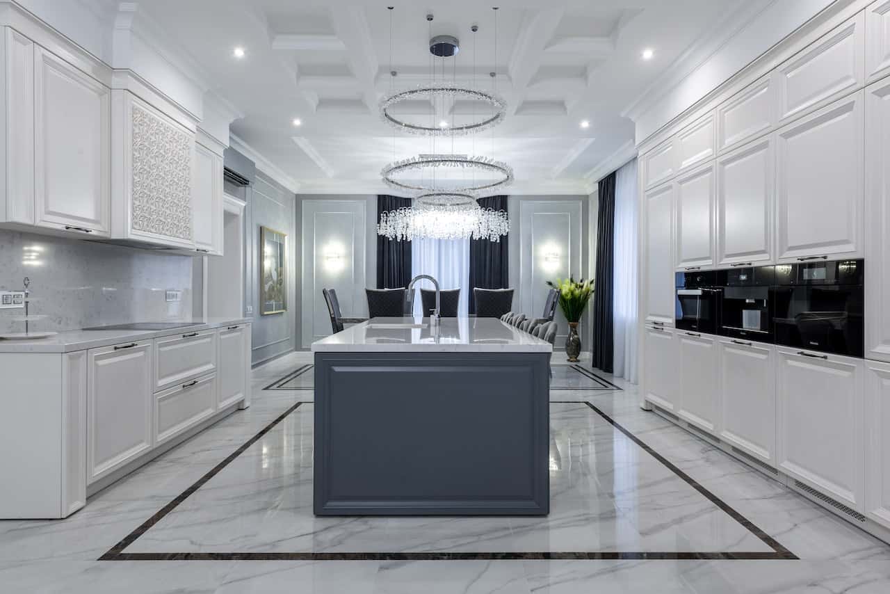 Luxurious kitchen entrance design with white cabinets and chandelier