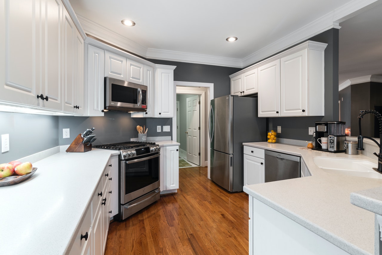 Sleek kitchen entrance design featuring stainless steel appliances and countertops