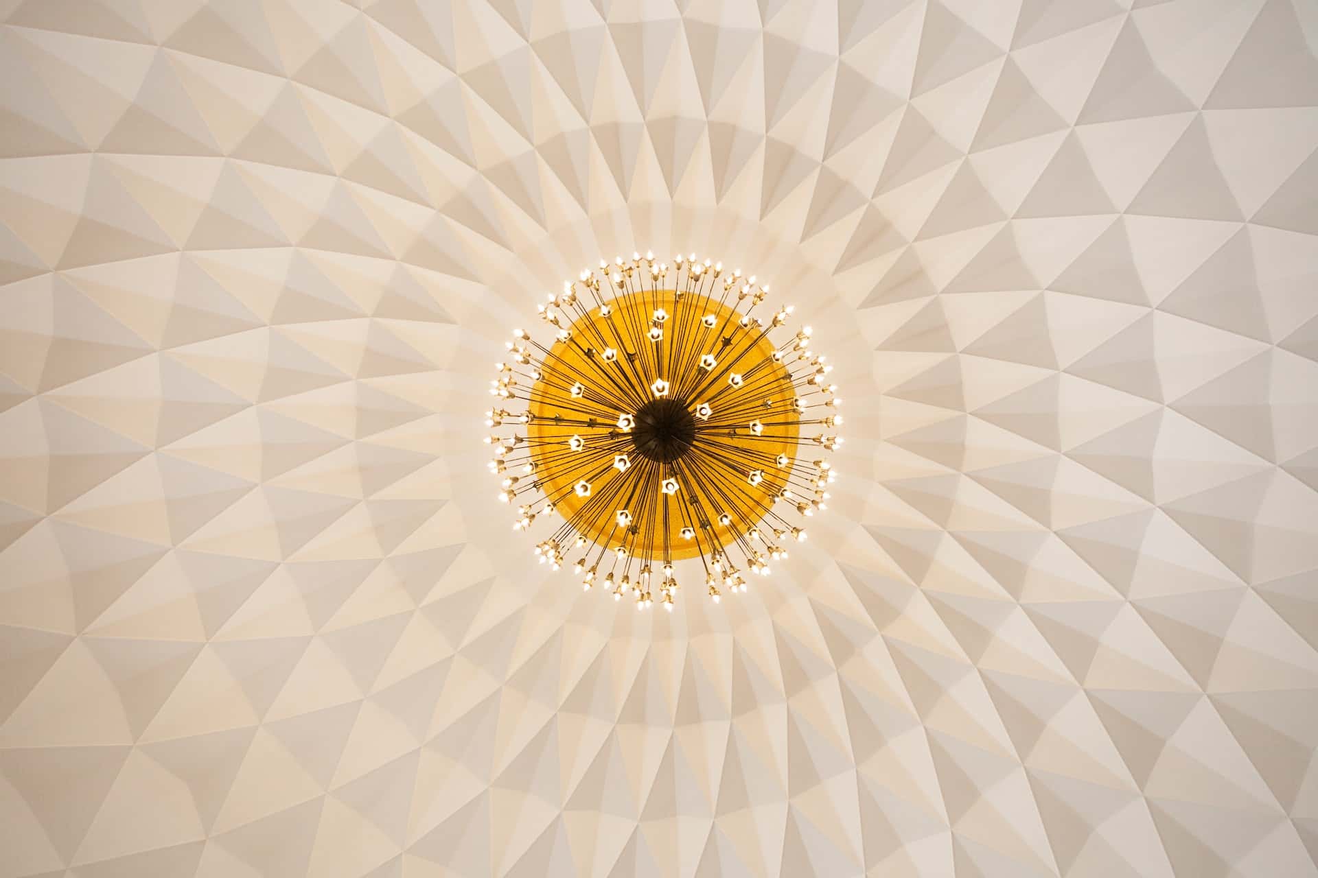Geometric modern ceiling design with golden chandelier centerpiece