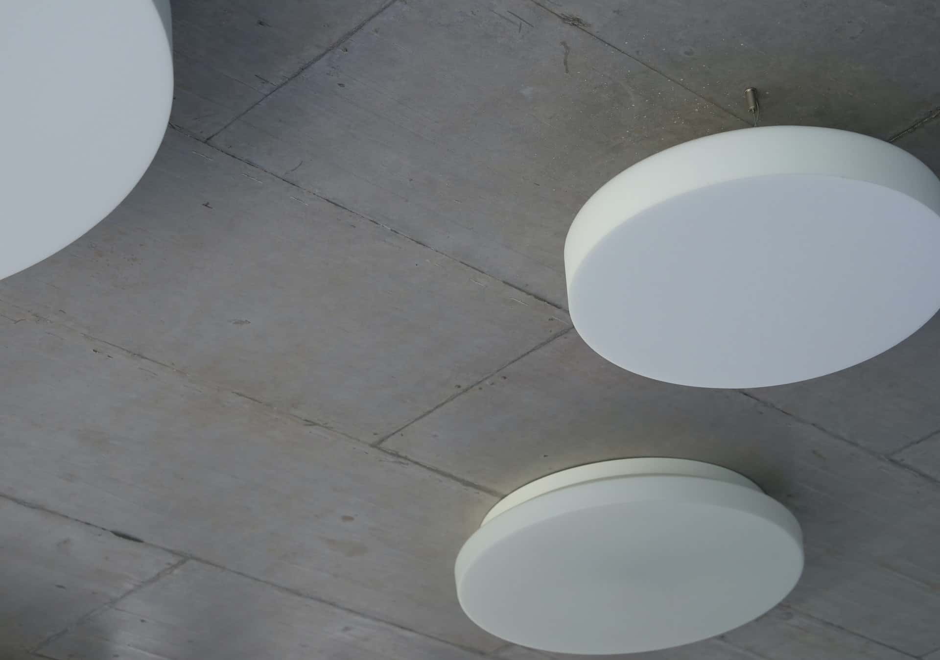 Modern pop design for ceiling with minimal round light fixtures on concrete finish